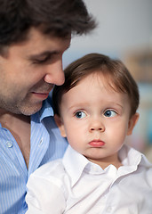 Image showing Pout Boy on Father\'s Knees