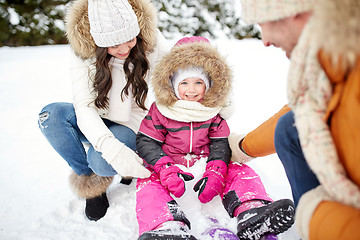 Image showing happy family with sled walking in winter outdoors