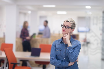 Image showing portrait of young business woman at office with team in backgrou