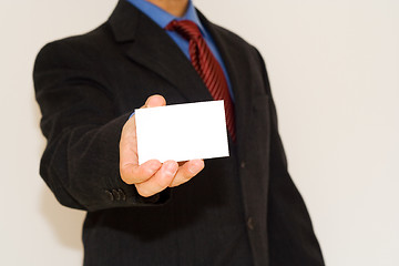 Image showing business man holding a white card