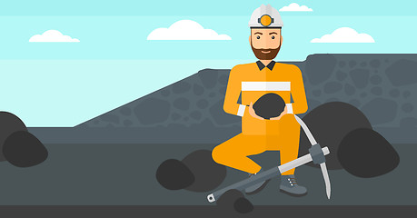 Image showing Miner holding coal in hands.