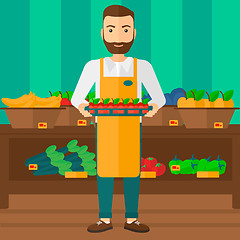 Image showing Supermarket worker with box full of apples.