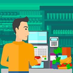 Image showing Cashier at supermarket checkout.