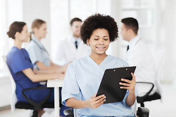 Image showing happy doctor over group of medics at hospital