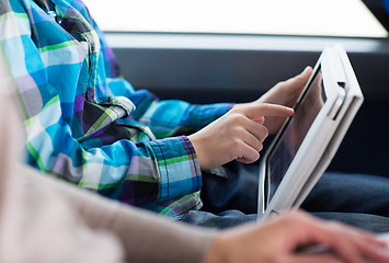 Image showing close up of boy with tablet pc in travel bus