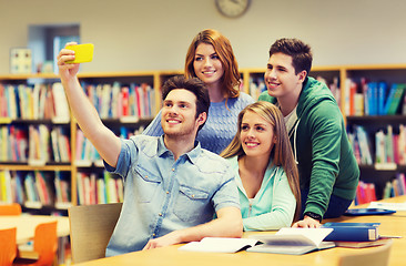 Image showing students with smartphone taking selfie at library