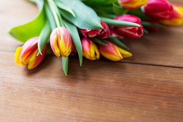 Image showing close up of tulip flowers on wooden table