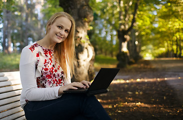 Image showing Young woman using her laptop in the park