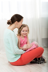 Image showing Mother kissing dear little daughter