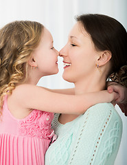 Image showing Mother and daughter touching with noses