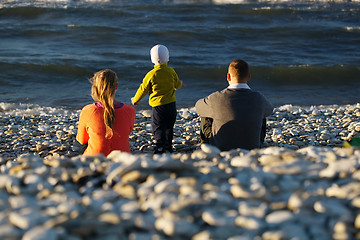 Image showing Family of three on pebble beach