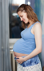 Image showing Pregnant woman stands in the room