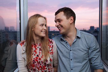 Image showing Young couple on the balcony looking to each other