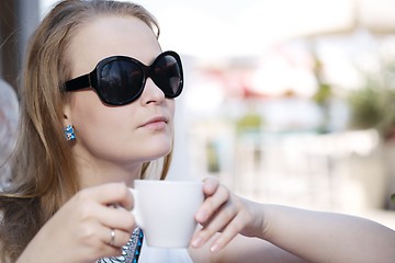 Image showing Young woman drinking coffee