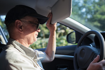 Image showing Senior driver hiding from the sun