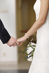 Image showing Bride and groom holding hands