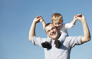 Image showing Dad giving his young son a piggy back ride