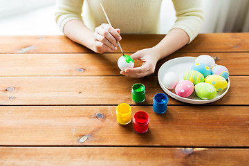 Image showing close up of woman hands coloring easter eggs