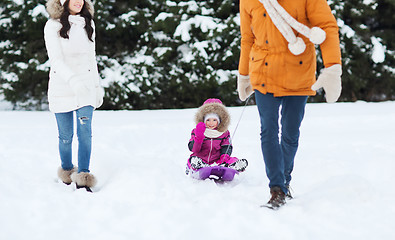 Image showing happy family with sled walking in winter forest