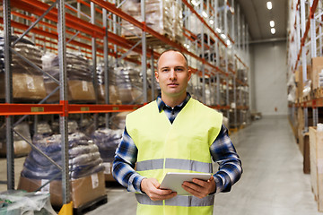 Image showing manual worker with tablet pc at warehouse