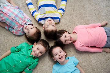 Image showing happy smiling little children lying on floor