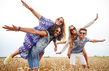 Image showing happy hippie friends having fun on cereal field