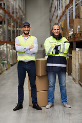 Image showing men in uniform with boxes at warehouse