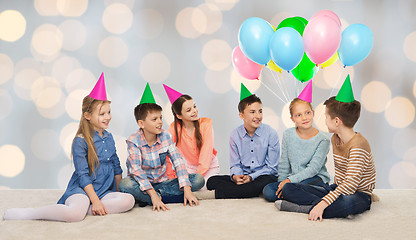 Image showing happy smiling children in party hats on birthday