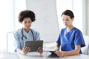 Image showing doctors with tablet pc meeting at hospital