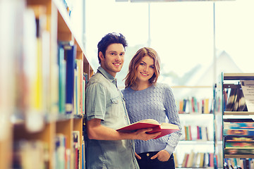 Image showing happy student couple with books in library