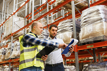 Image showing worker and businessmen with clipboard at warehouse