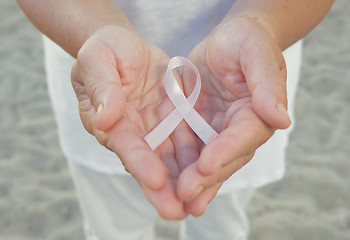 Image showing Hands holding pink ribbon