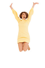 Image showing Adult woman in yellow dress jumping