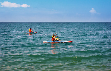 Image showing A walk along the sea on small boats.