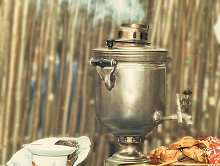 Image showing Boiling tea from the old samovar.