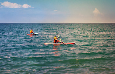 Image showing A walk along the sea on small boats.