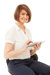 Image showing Beautiful smiling businesswoman holding pad 