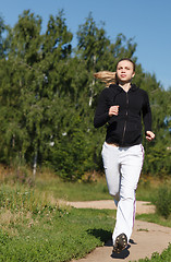 Image showing Girl running in the park. Wide shot