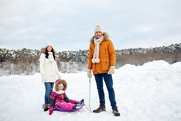 Image showing happy family with sled walking in winter outdoors