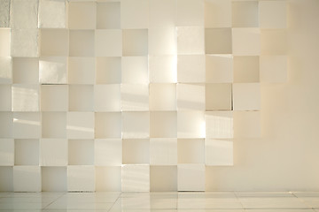 Image showing White painted concrete wall made of cubes with tiled floor