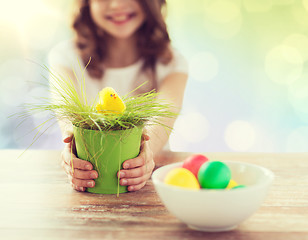 Image showing close up of girl holding pot with easter grass