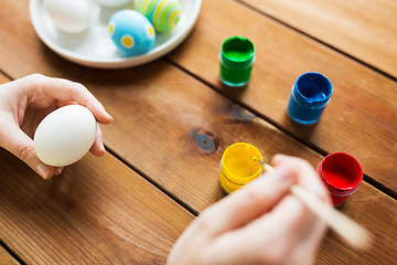 Image showing close up of woman hands coloring easter eggs