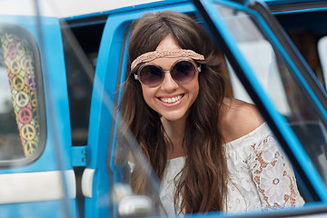 Image showing smiling young hippie woman in minivan car