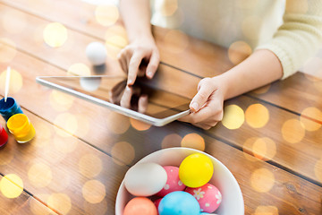 Image showing close up of woman with tablet pc and easter eggs