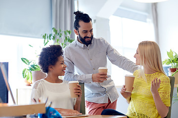 Image showing happy creative team drinking coffee in office