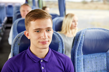 Image showing happy young man sitting in travel bus or train