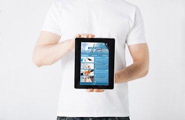 Image showing close up of man with business news on tablet pc