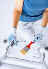 Image showing woman with paintbrush and paint pot