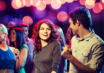 Image showing smiling friends dancing in club