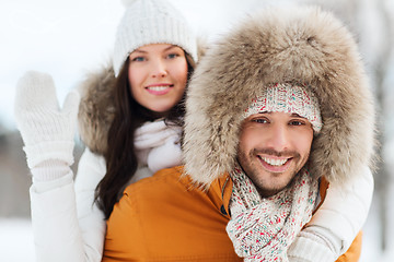 Image showing happy couple having fun over winter background